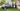 Group of men with EGO lawn mowers in a park setting