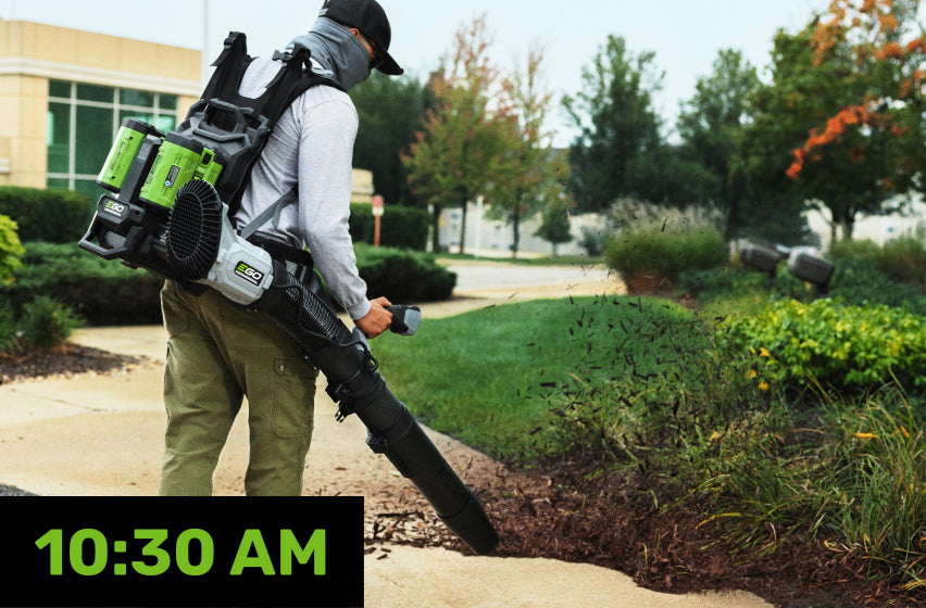 A landscaper using an EGO Commercial backpack blower