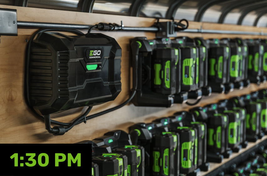 A PGX™ Commercial Charging 1600W Hub connected to a row of EGO 56V ARC Lithium™ batteries